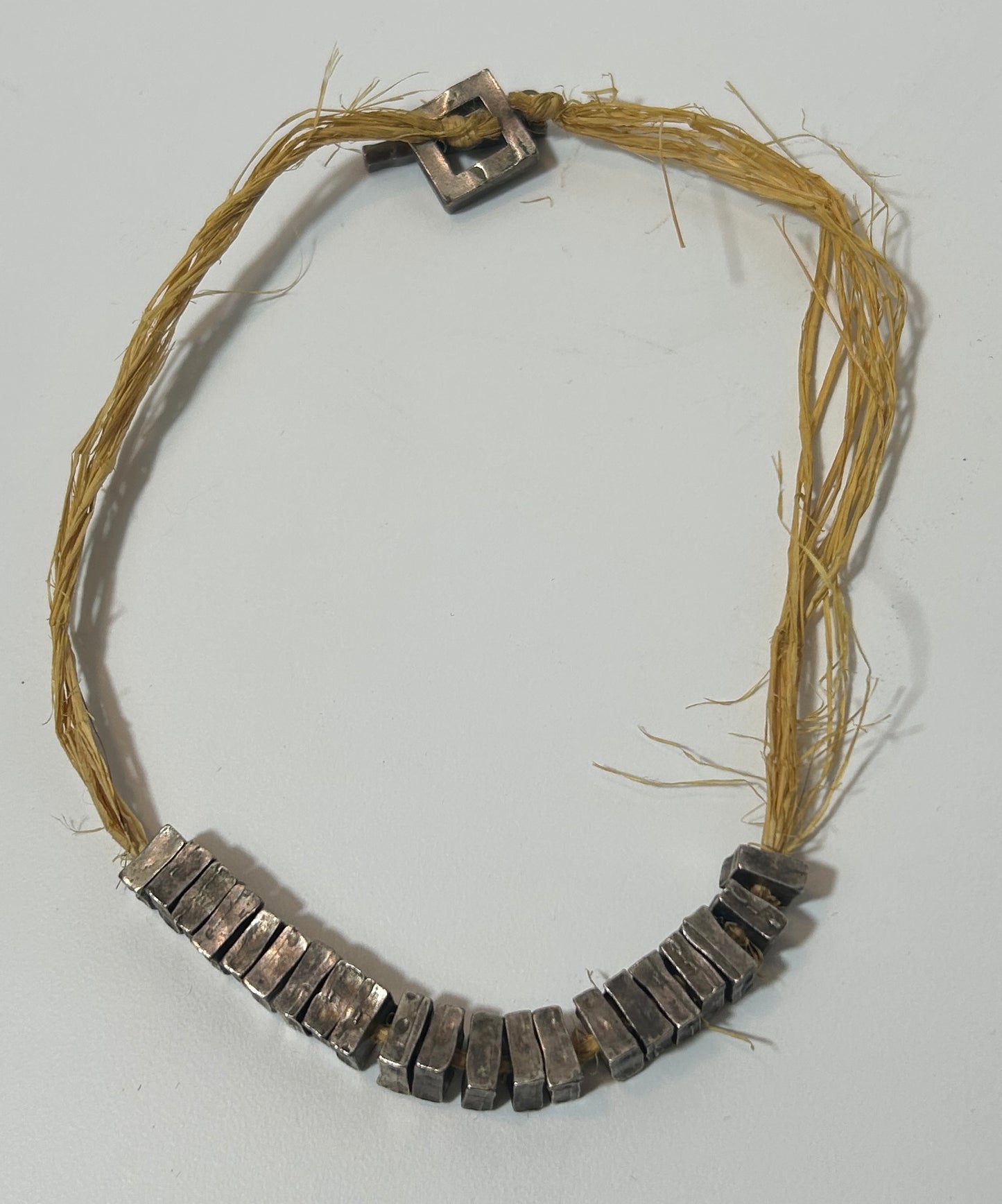 Rustic Artisan Necklace with Textured Metal Beads on Natural Raffia Cord – Statement Tribal Boho Jewelry